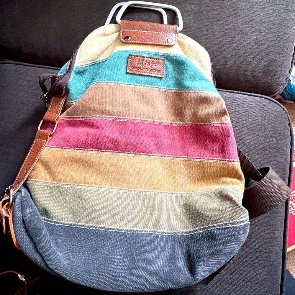Multicolored canvas bag with metal handles can make backpack or purse strap